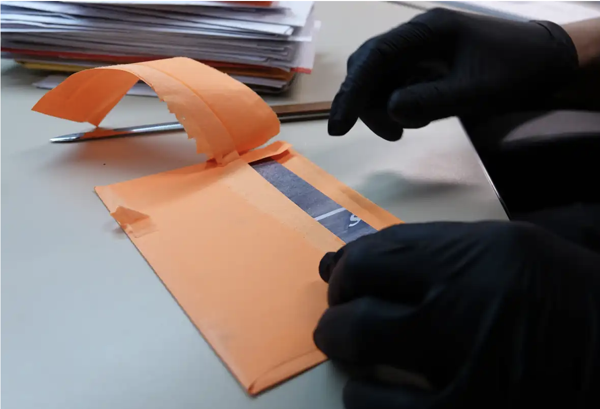 Gloves opening mail for drug detection