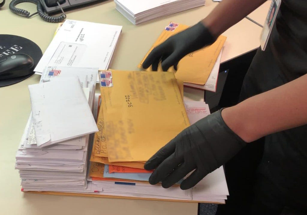Person manually screening mail