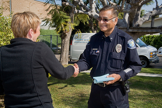 Police man shaking woman's hand